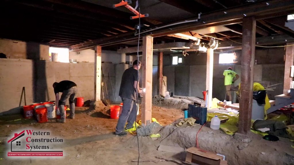 group of men repairing a foundation