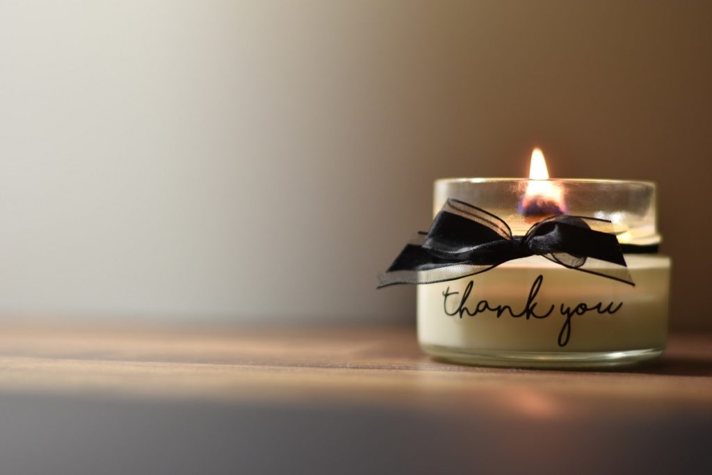 a candle with thank you written on it