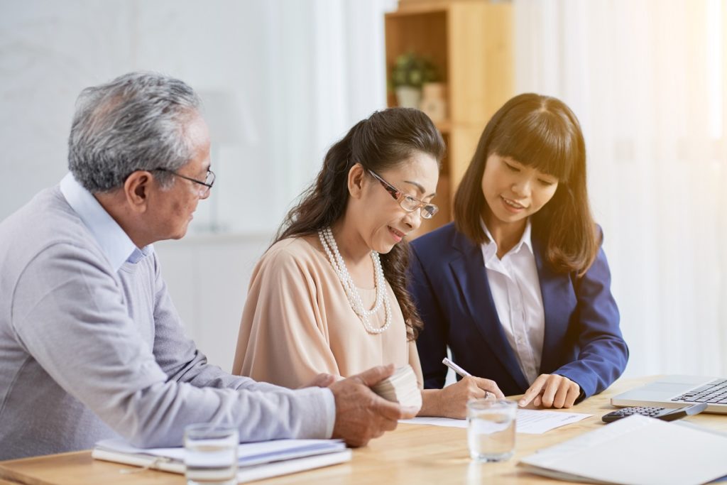 older couple signing papers