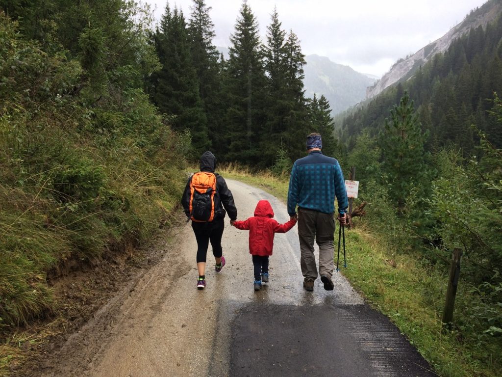 two adults and a child taking a walk