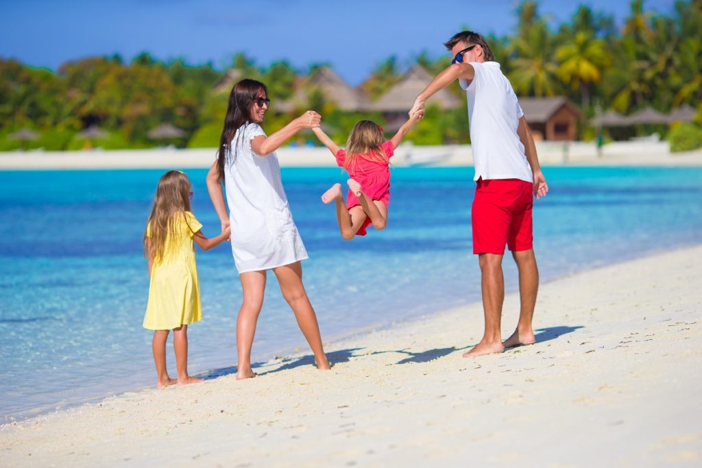 Happy beautiful family on a beach during summer vacation