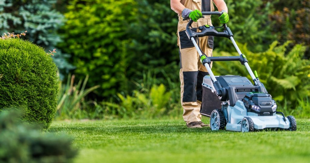 a professional landscaper mowing the lawn