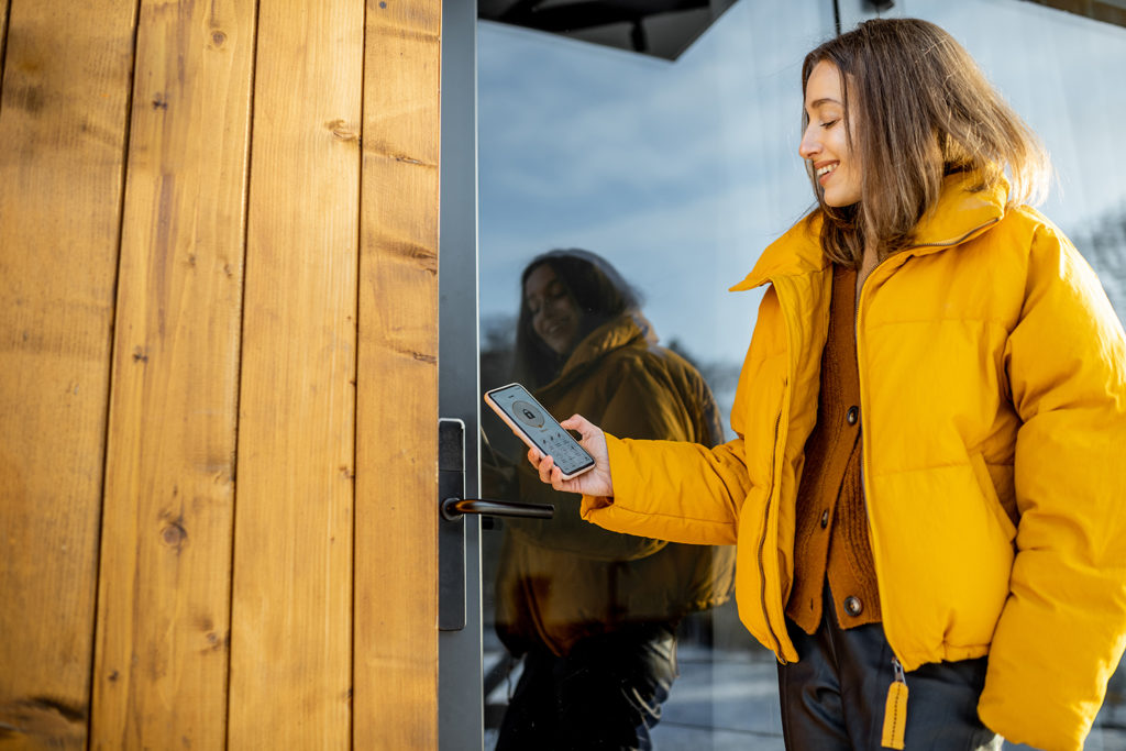 Person unlocks home smart lock with cell phone