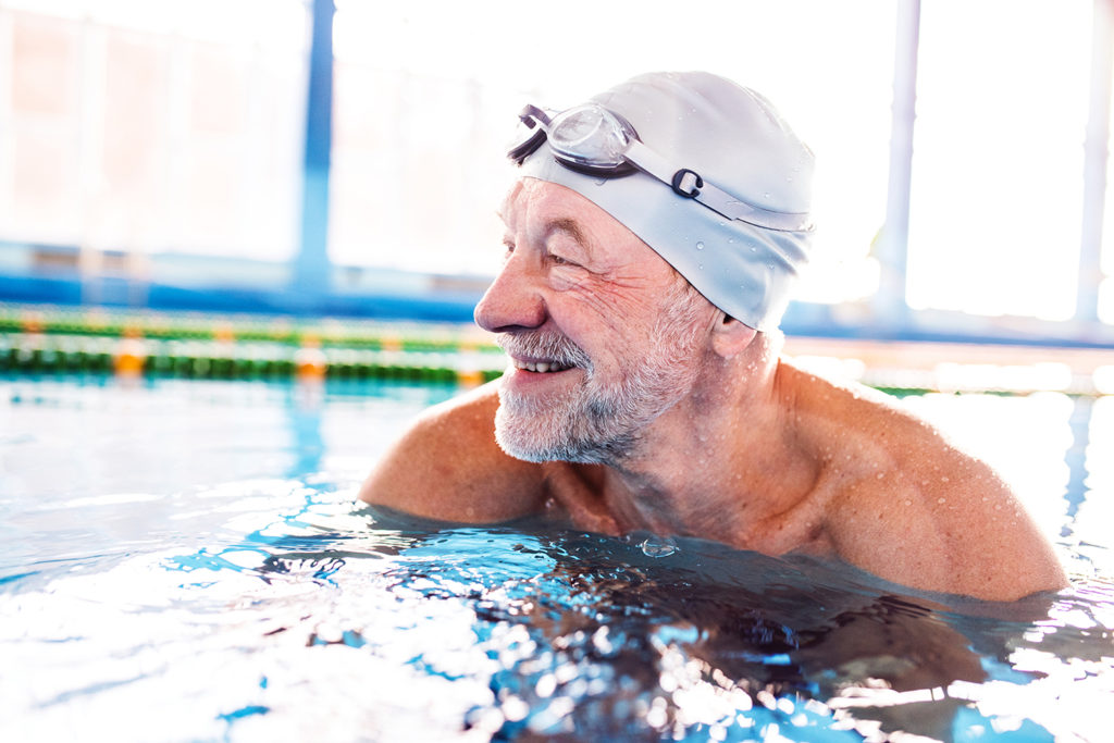 senior man swimming in pool