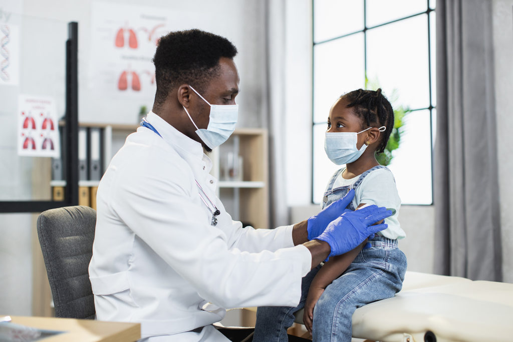 Pediatrician keeping child patient up-to-date with immunizations